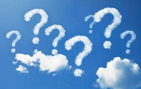 Photograph of a blue sky with fluffy white clouds in the shape of question marks